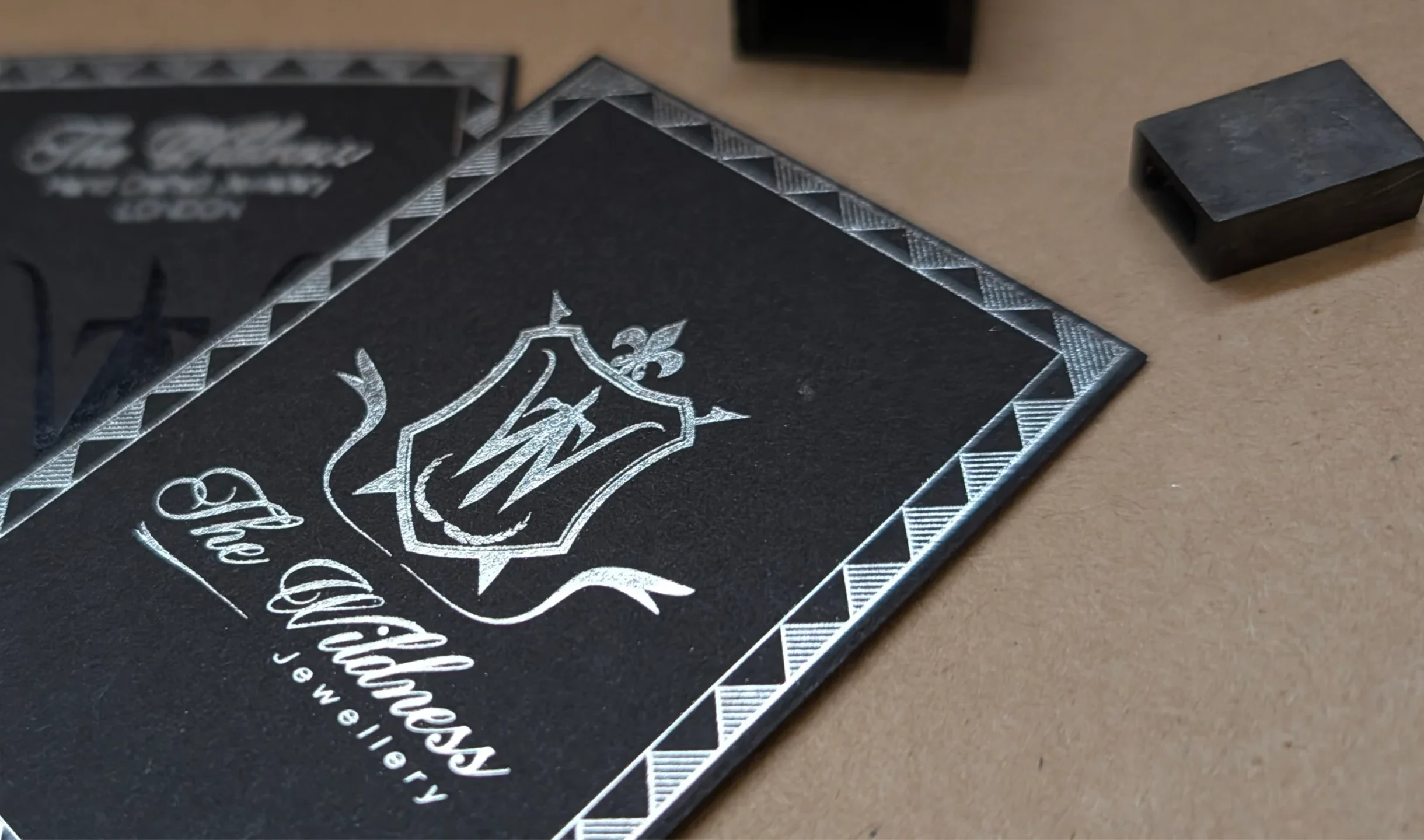 black business card printed with silver foil